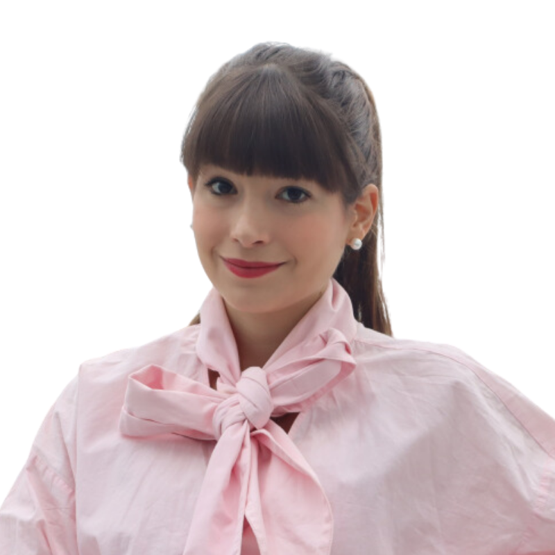 a woman wearing a pink shirt and a pink bow tie.